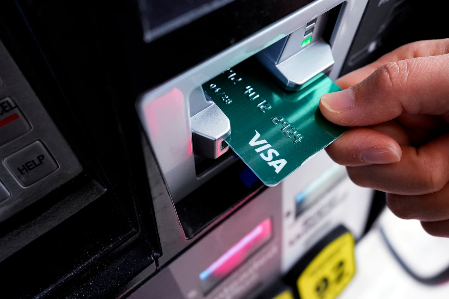 A customer uses a credit card to pay for gasoline at a gas station in Mundelein, Ill., Feb. 8, 2024.