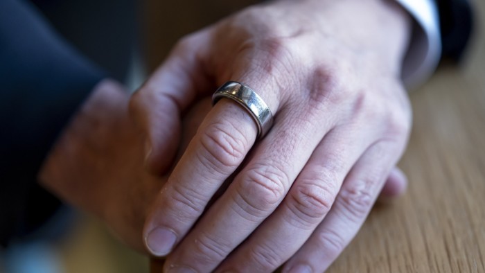 An Ōura ring on a hand