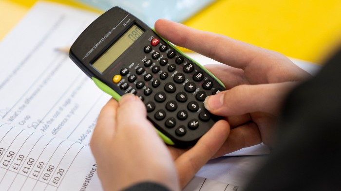 A person holding a calculator